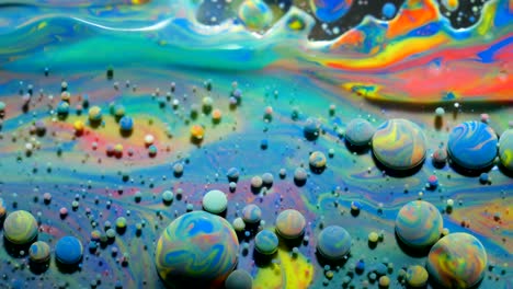 slow motion bright colors bubbles oil beautiful paint universe color moving multicolored closeup. acrylic paint. fantastic surface. abstract colorful paint metamorphosis structure colorful bubbles