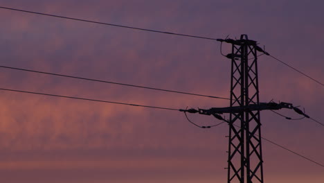 Medium-shot-of-an-electricity-pylon-at-sunrise