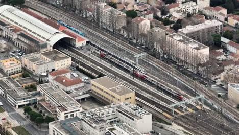 soaring above avignon's train hub, capturing its intricate layout and connectivi