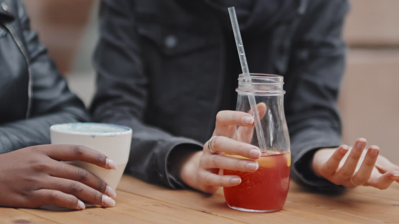 Women Having Drinks Outside and Talking
