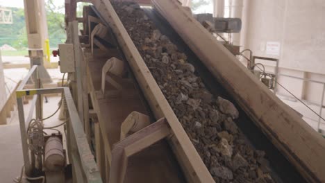 indoor conveyor belt move crushed rocks through manufacturing process, czechia