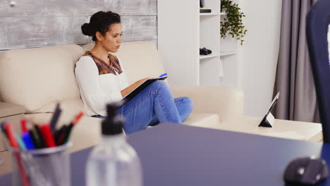 adult woman writing notes on clipboard