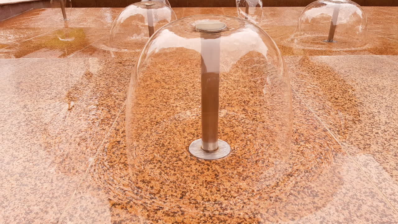 Fountains spaying spherical water bubbles