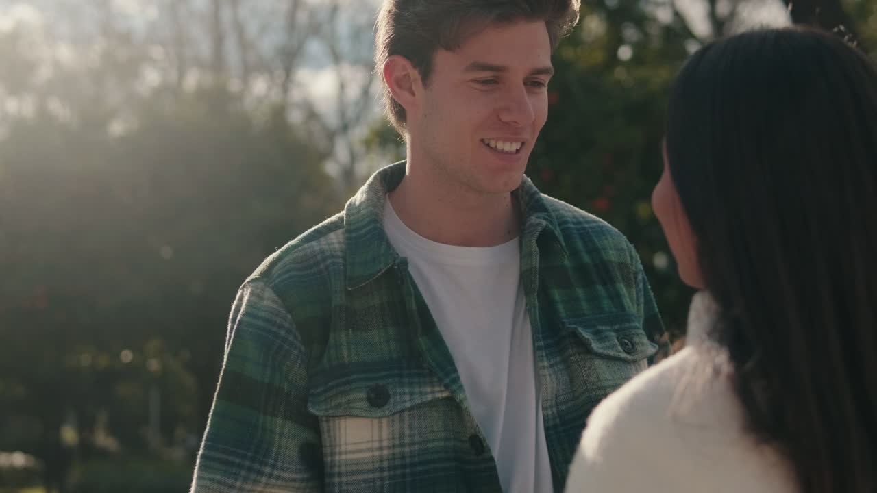Young intimate young pair man and woman talking standing on the street