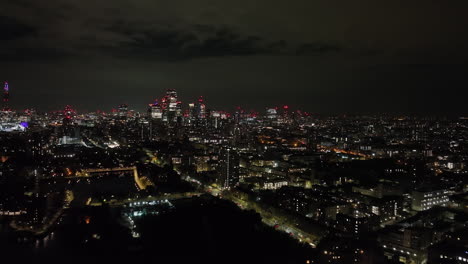 aerial overview of the shadwell district, london city skyline backdrop by night
