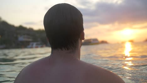 Swimmer-Looking-Out-Over-Ocean-at-Sunset