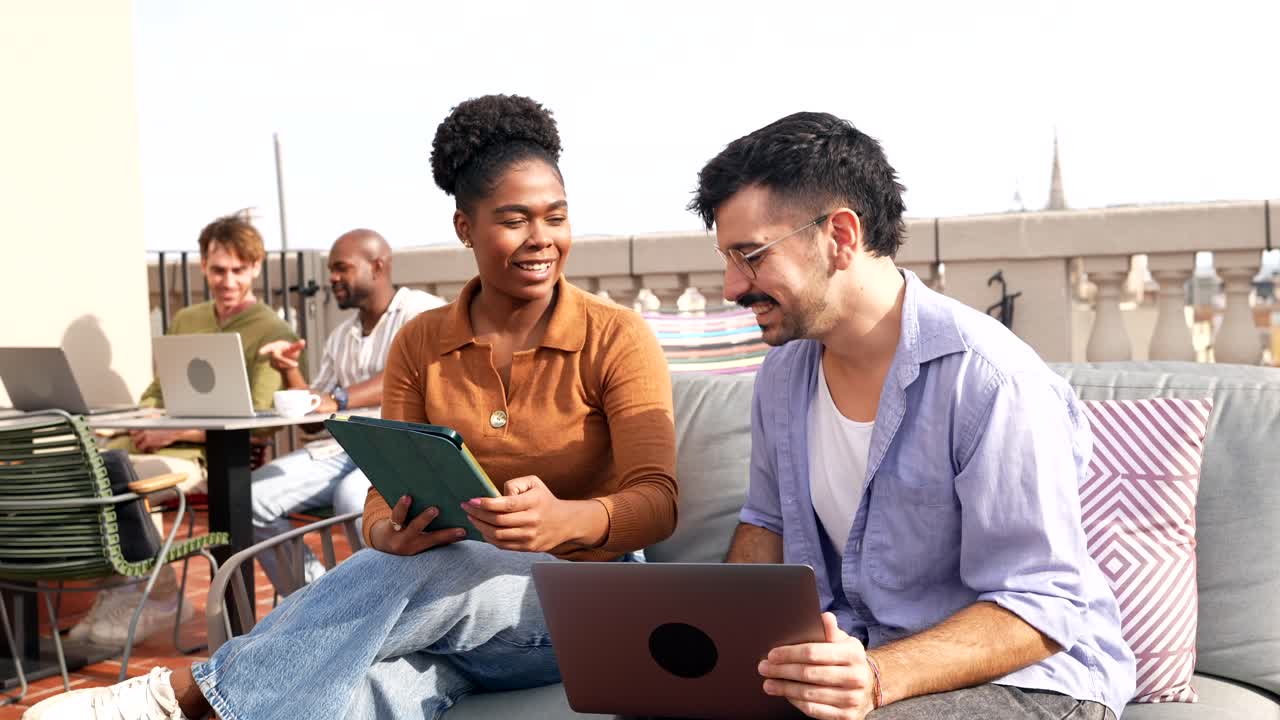 Diverse Young Professionals Collaborating on a Rooftop Terrace