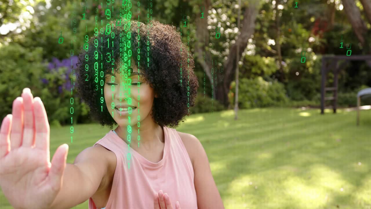 Woman raising right hand with open palm sparking falling green code hiding face fading showing tech