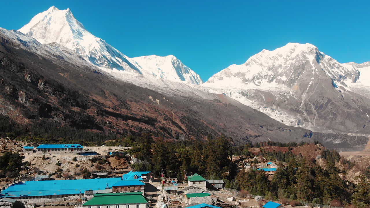 Aerial view of Manaslu Range, the eighth highest peak in the world, and Shyala Village in remote Manaslu Conservation Area of Nepal