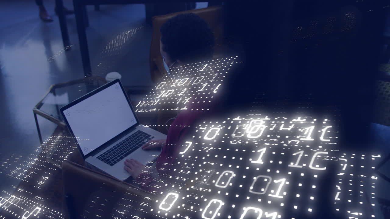 Using laptop, person viewing binary code animation overlay in school setting