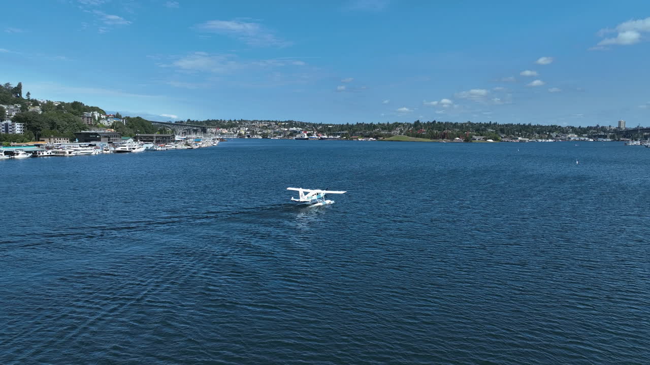 Drone shot tracking a seaplane floating on a lake, sunny, summer day in USA