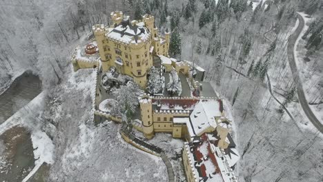 aerial view of hohenschwangau flying around the castle poi in winter