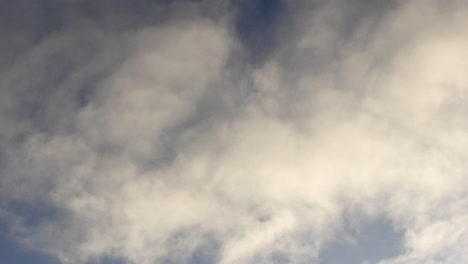 timelapse of fluffy clouds passing by on a blue sky