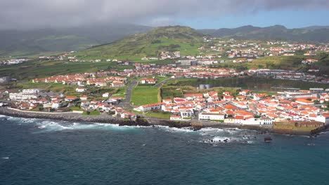 horta suburbs amidst green volcanos and atlantic ocean, faial, azores