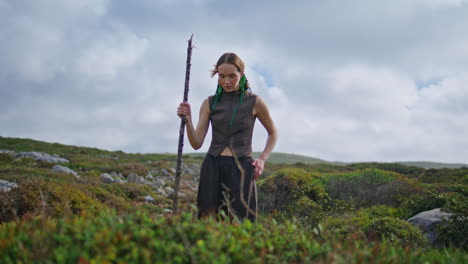 adventure woman posing hill at cloudy sky. serene traveler contemplating green