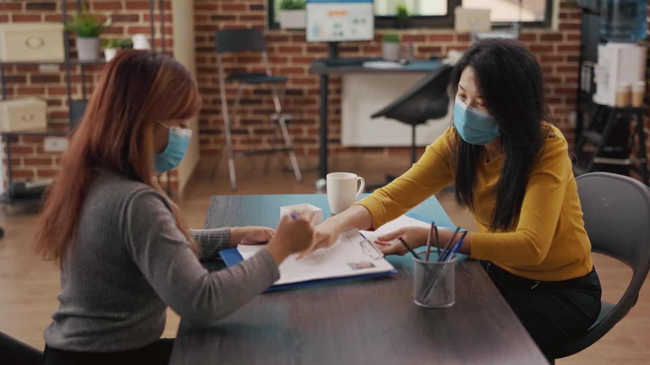 Job candidate signing recruitment documents at interview meeting