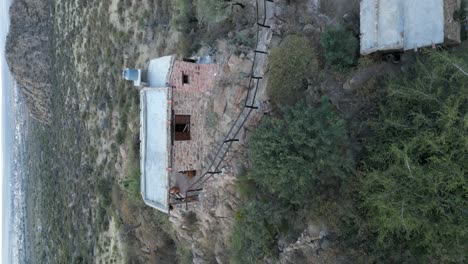 Vertical-shot-of-cabin-on-top-of-mountain-on-outskirts-of-Salta,-Argentina