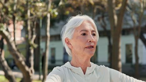 senior woman stretching and exercising in a park