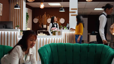 receptionist welcoming asian woman at five star resort