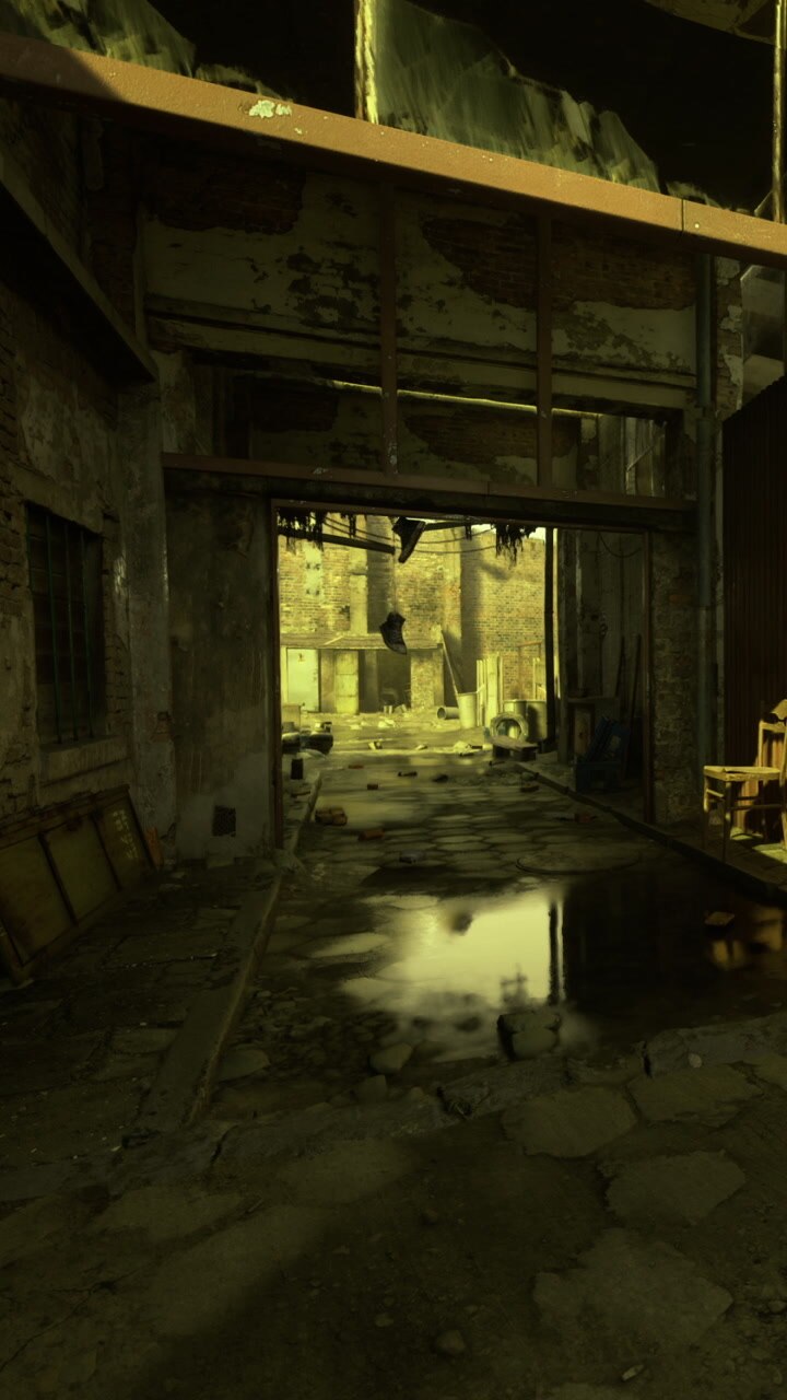 Old warehouse with broken walls and puddles in a narrow alley at dusk