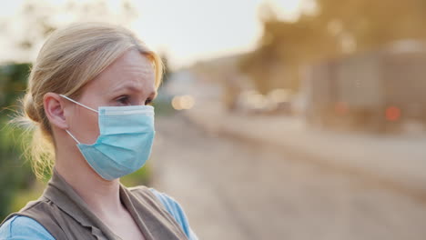 A-Woman-In-A-Protective-Mask-On-A-Dusty-Road-Ecology-Problems-Concept