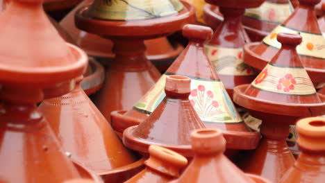 Colourful-stack-of-traditional-handmade-tagine-glazed-pots-on-display-in-Marrakesh-bazaar-food-market