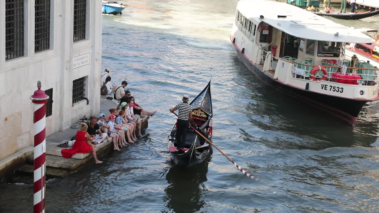 Charming Venice canal with bridge and colorful old buildings.