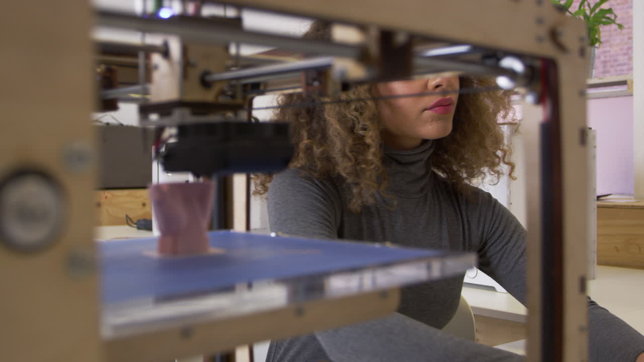 Female designer working with 3D printer in a design studio, shot on R3D