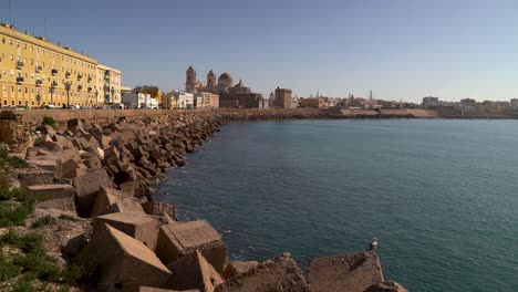 wide open view toward wave breakers and road in cadiz, spain