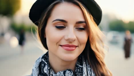 a young woman smiles while posing for a portrait on a city street