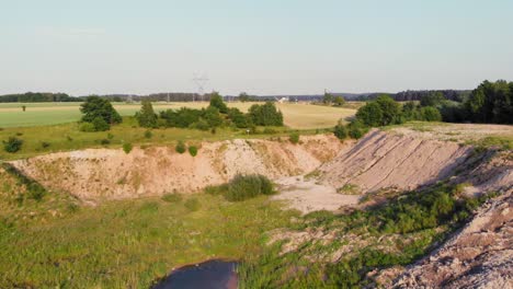 Aerial-dolly-shot-of-dunes-and-pits-in-a-sand-mine-