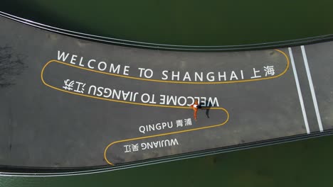 welcome to shanghai greeting in china - aerial top down drone view