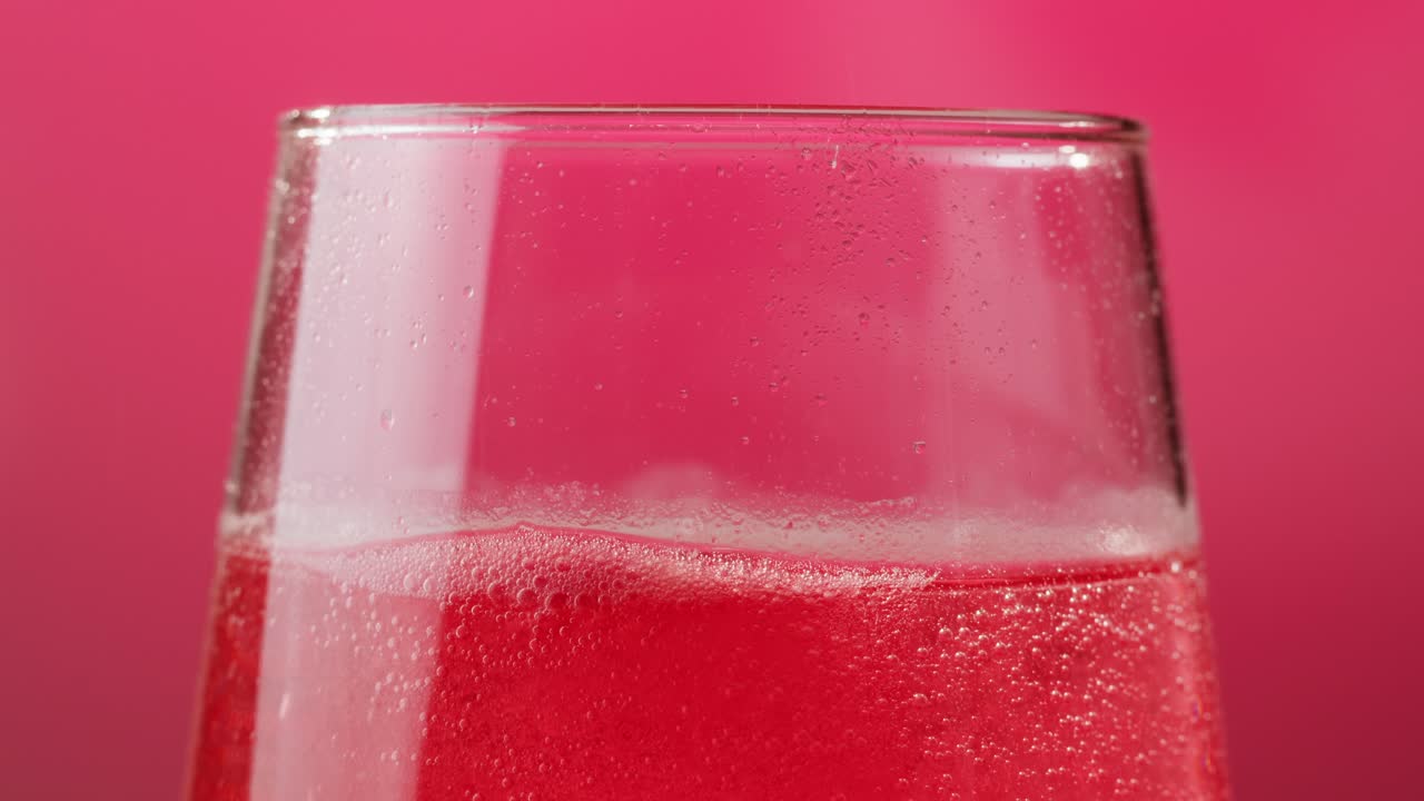 Close-up of a Sparkling Pink Drink in a Wine Glass