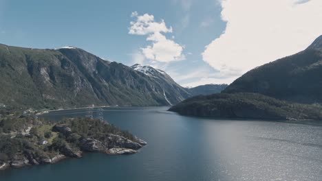 high voltage power lines crossing across fjord in valldal in norway, aerial view