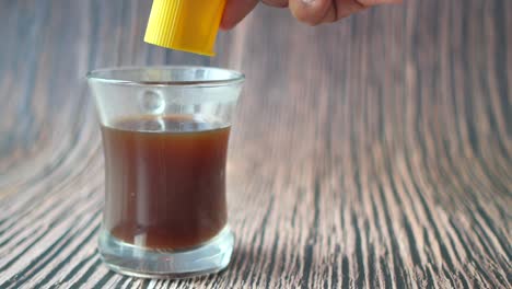adding sweetener to coffee