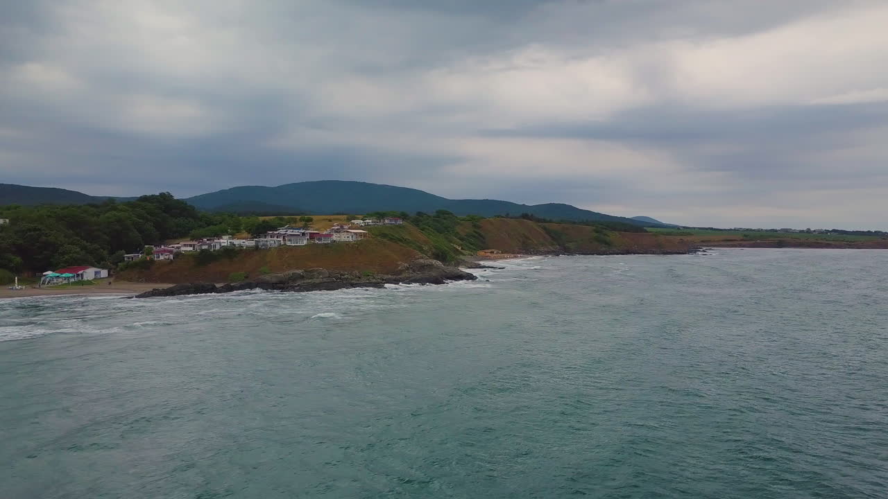 Drone flying above sea to the beach in winter