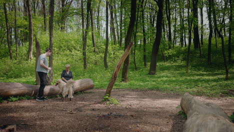 family enjoying a walk in the forest with a dog