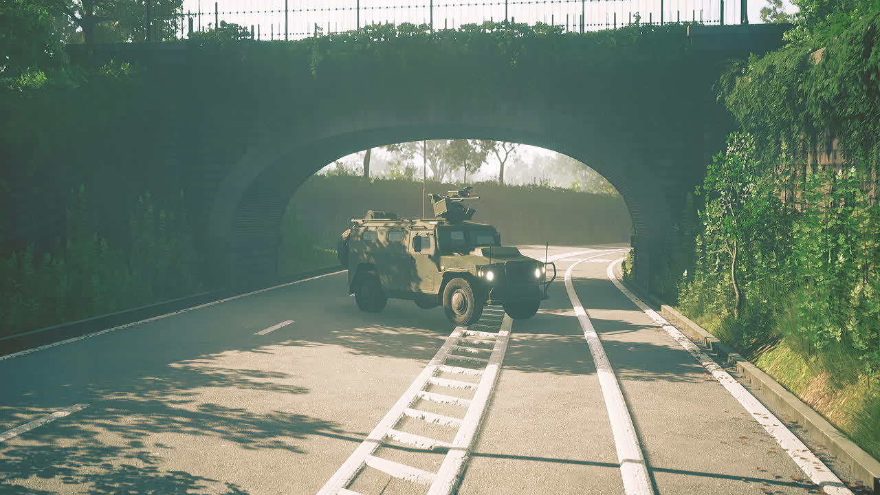 Military vehicle navigates a serene road beneath a lush green archway