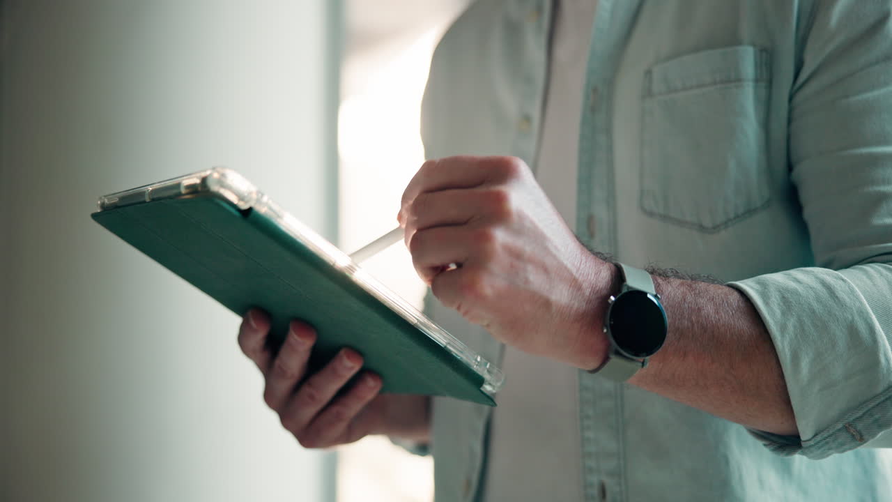 Man Using Tablet with Stylus