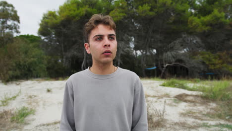 boy looks amazed at an animal in the forest at daytime in nature