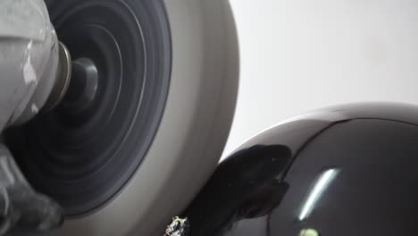 A-view-of-someone-polishing-a-helmet-of-a-motorbike