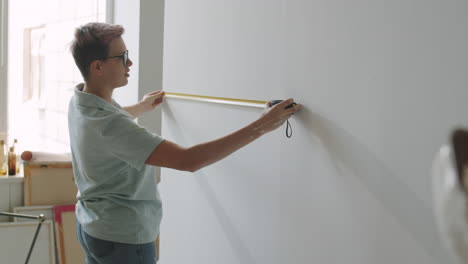 measuring wall in a studio apartment