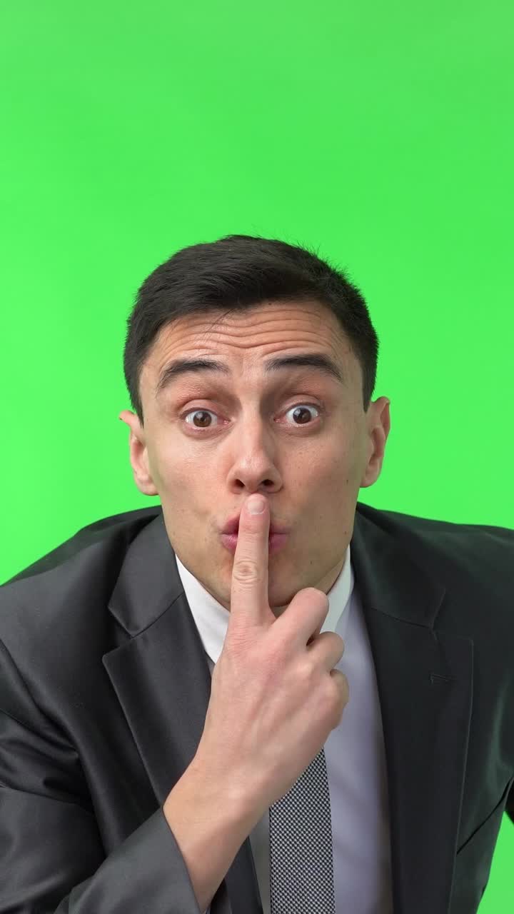 Businessman Reacts with Surprise, Shock, and a Shushing Gesture on Green Screen