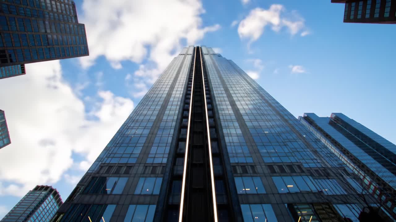 A Stunning View from Below: Capturing the Skyline Ascent of a Modern Skyscraper in Bright Daylight, Showcasing Urban Architecture and Innovative Design