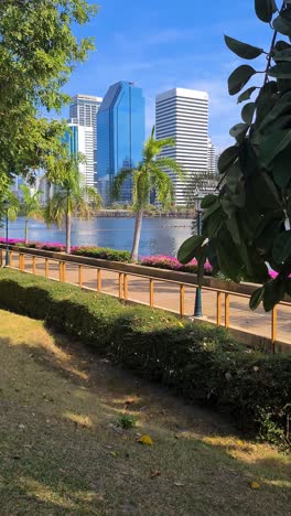vertical view, modern residential and office towers in bangkok, thailand, benjakitti park lake view
