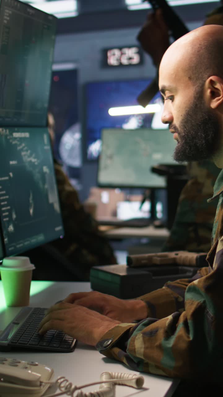 Vertical video Army specialist overseeing national safety operations with devices, close up