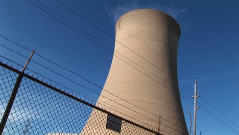 a nuclear power plant is protected by a high cyclone fence and barbedwire