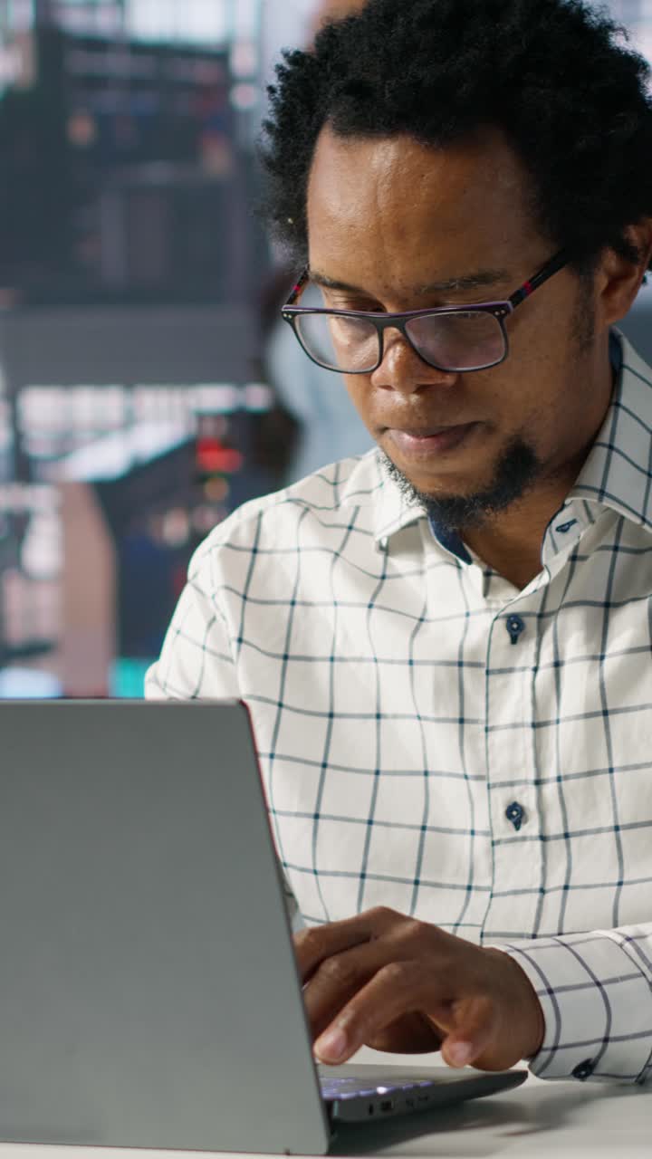 African American Man Working on Laptop in Office