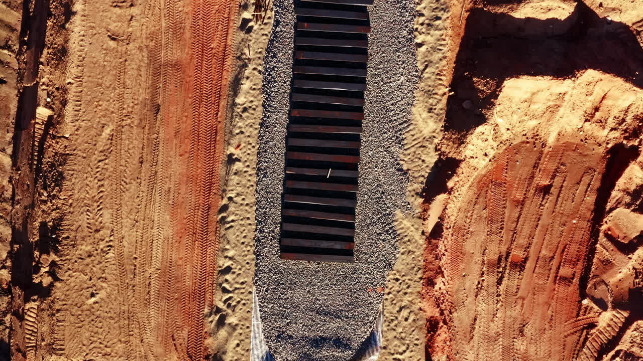Close Aerial of Railway Track construction on Gravel through Construction Zone