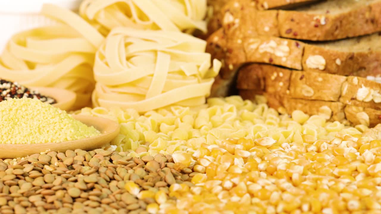 A variety of grains and sliced bread arranged in a well-lit setting, highlighting textures and colors